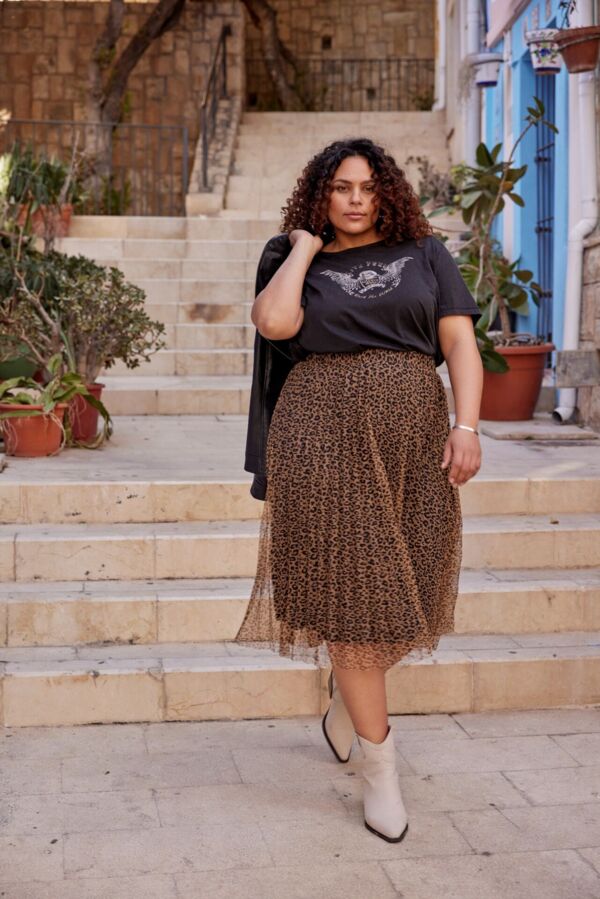 Weibliches Plus Size Model in luftigen Muster-Rock und T-Shirt